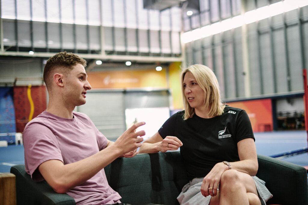 Two people talking together on a couch