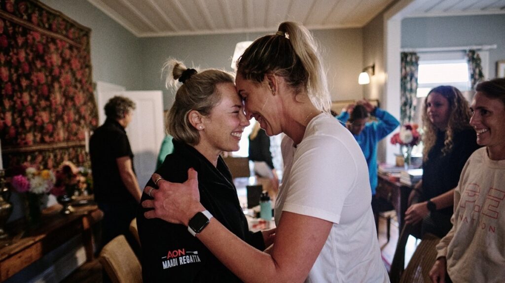 Two women embracing at a summit