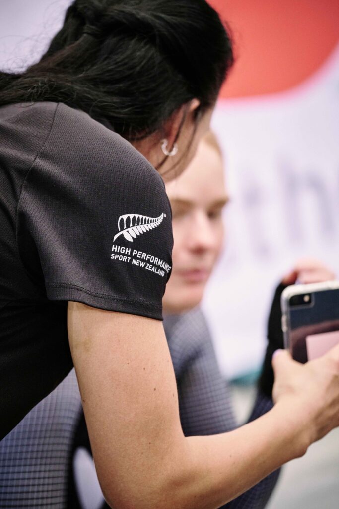 Coaching showing athlete something on their phone